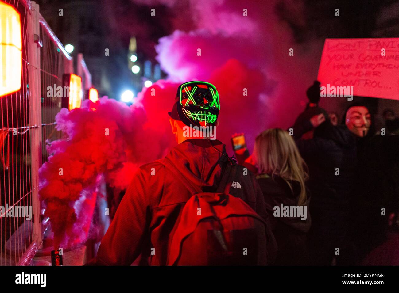 A coloured smoke bomb lit during the Million Mask March attended by many lockdown sceptics, London, 5 November 2020 Stock Photo