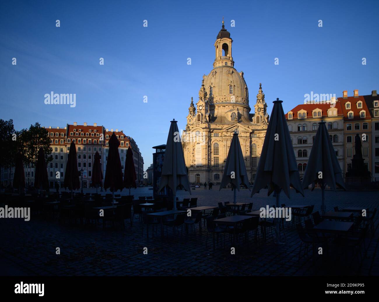 Dresden, Germany. 06th Nov, 2020. The Frauenkirche on the Neumarkt is illuminated by the sun in the afternoon, while folded umbrellas, tables and chairs from restaurants stand in the shade. The federal and state governments have decided on a partial lockdown. Among other things, restaurants, leisure facilities and cultural institutions will have to close. This still includes the distance requirement and the obligation to wear masks. Credit: Robert Michael/dpa-Zentralbild/dpa/Alamy Live News Stock Photo