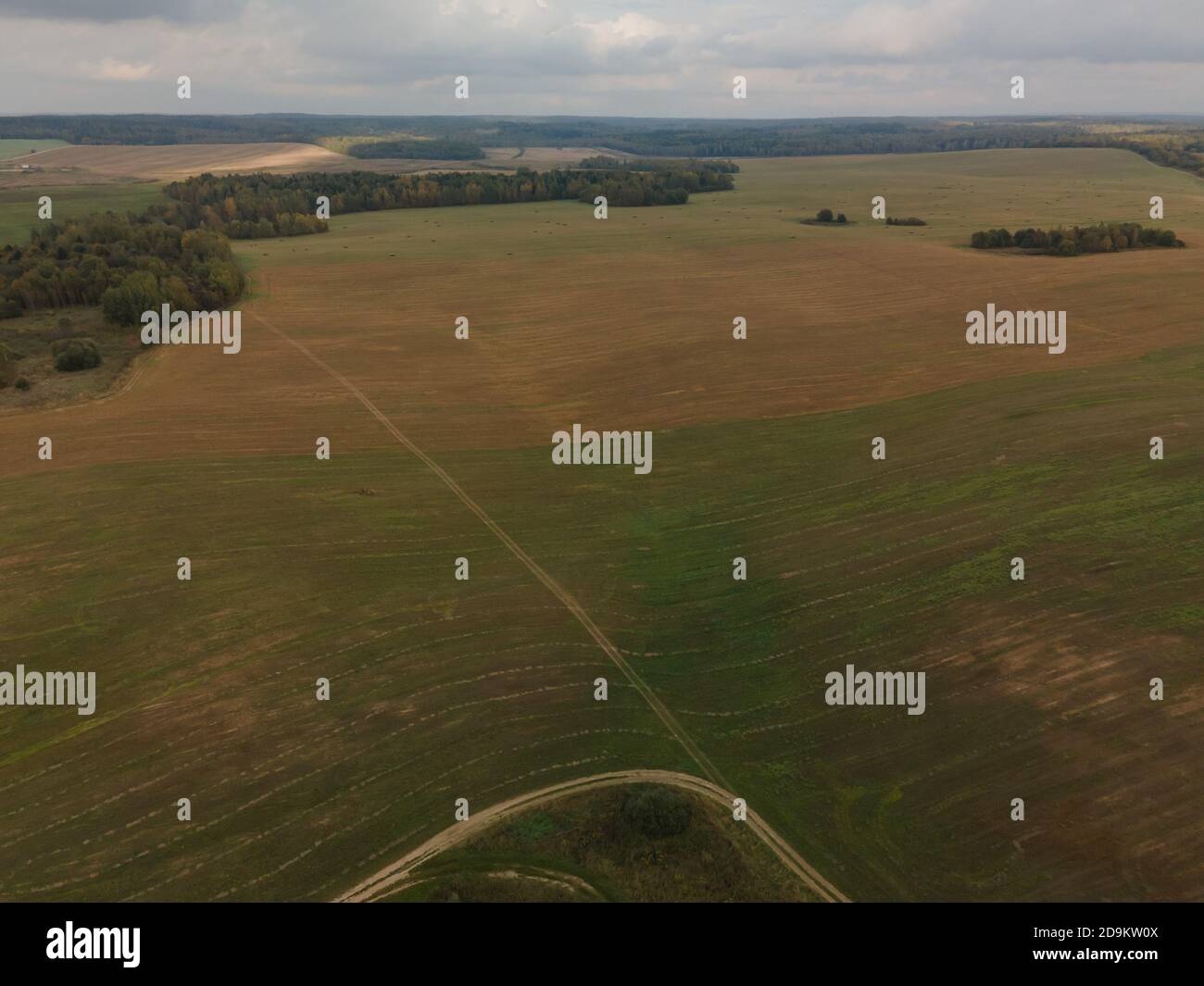 Landscape view from drone, yellow and green fields and haystacks, sky ...