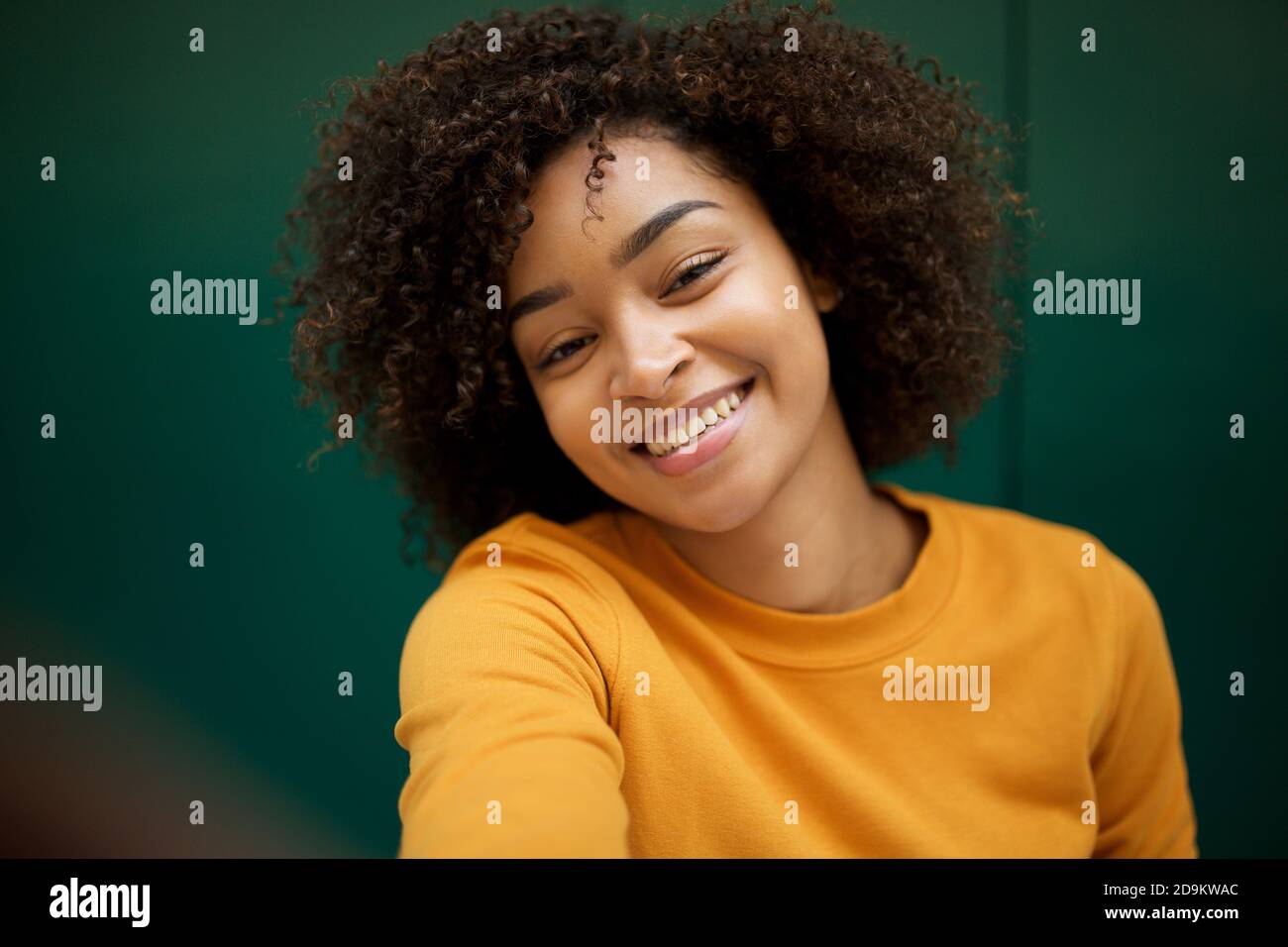 Close up portrait smiling young African american woman taking selfie ...