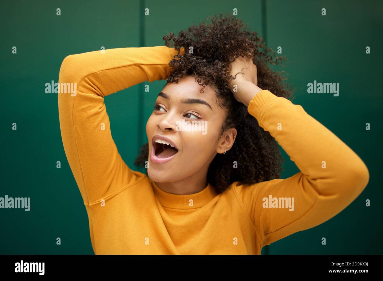 Close up portrait cheerful African american young woman with hands in ...