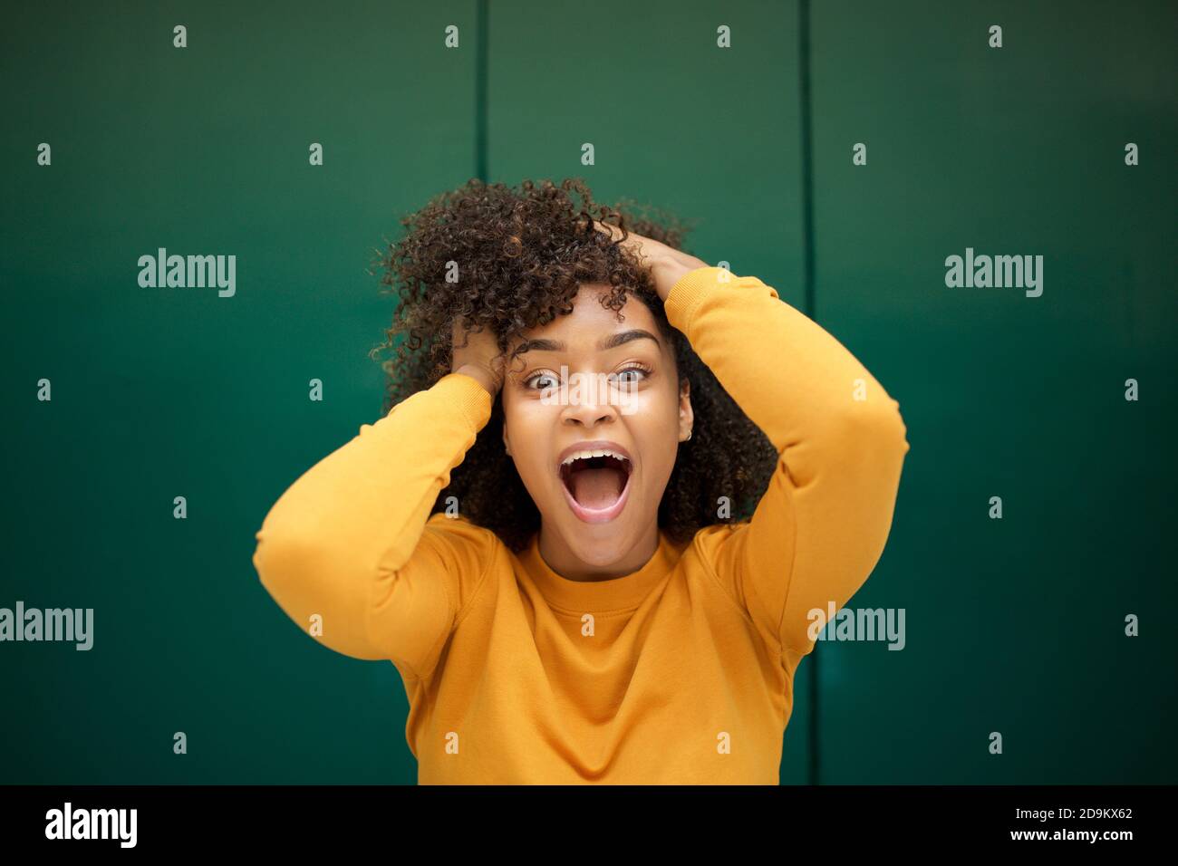 Close up portrait surprised young African american woman with hands in ...