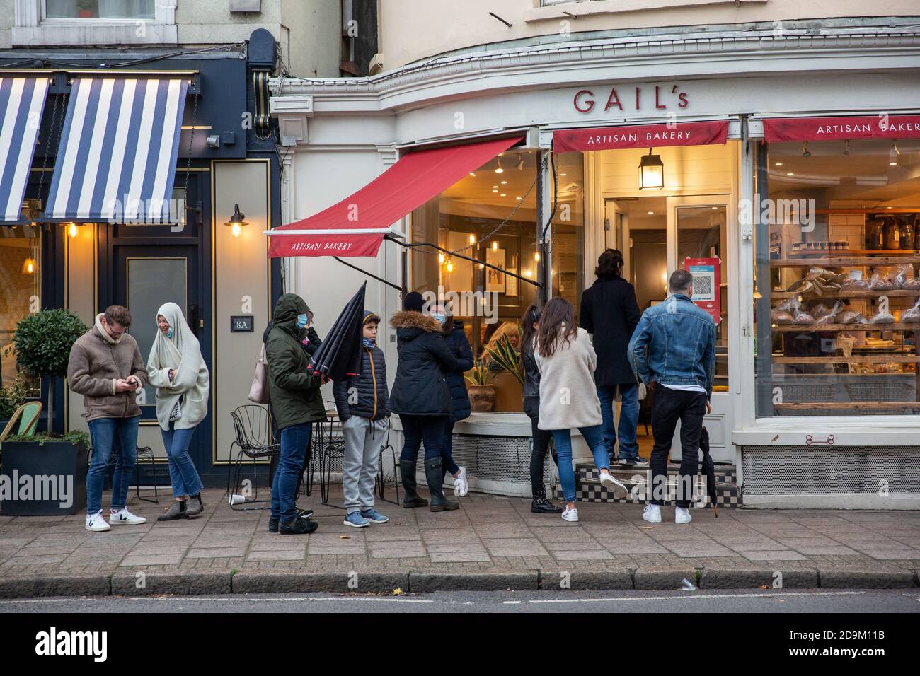 Queues build outside Gail's bakery in Wimbledon Village during the countdown to the second coronavirus lockdown in November 2020 across England, UK Stock Photo