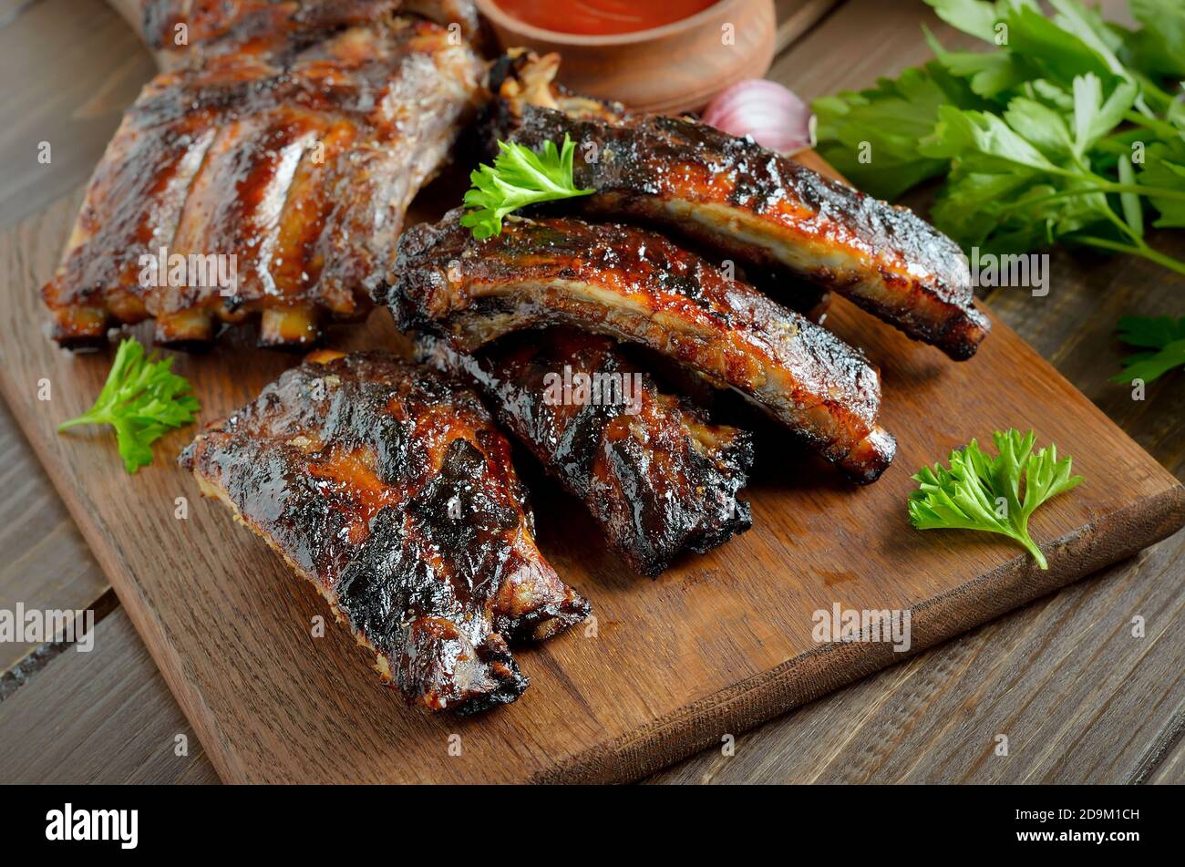 Barbecue pork ribs on cutting board, close up view Stock Photo