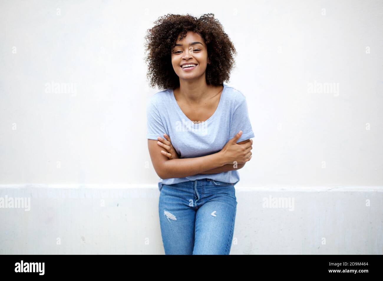 Portrait cute young african american woman with curly hair smiling by ...