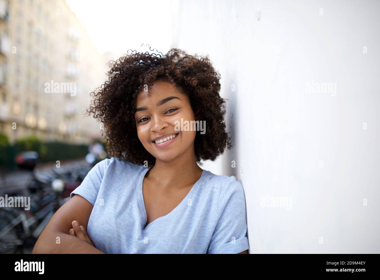 Close up portrait smiling young african american woman with curly hair ...