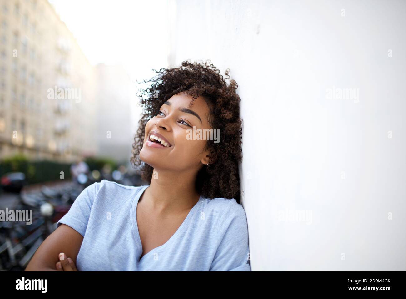 Close up portrait happy young african american woman with curly hair ...
