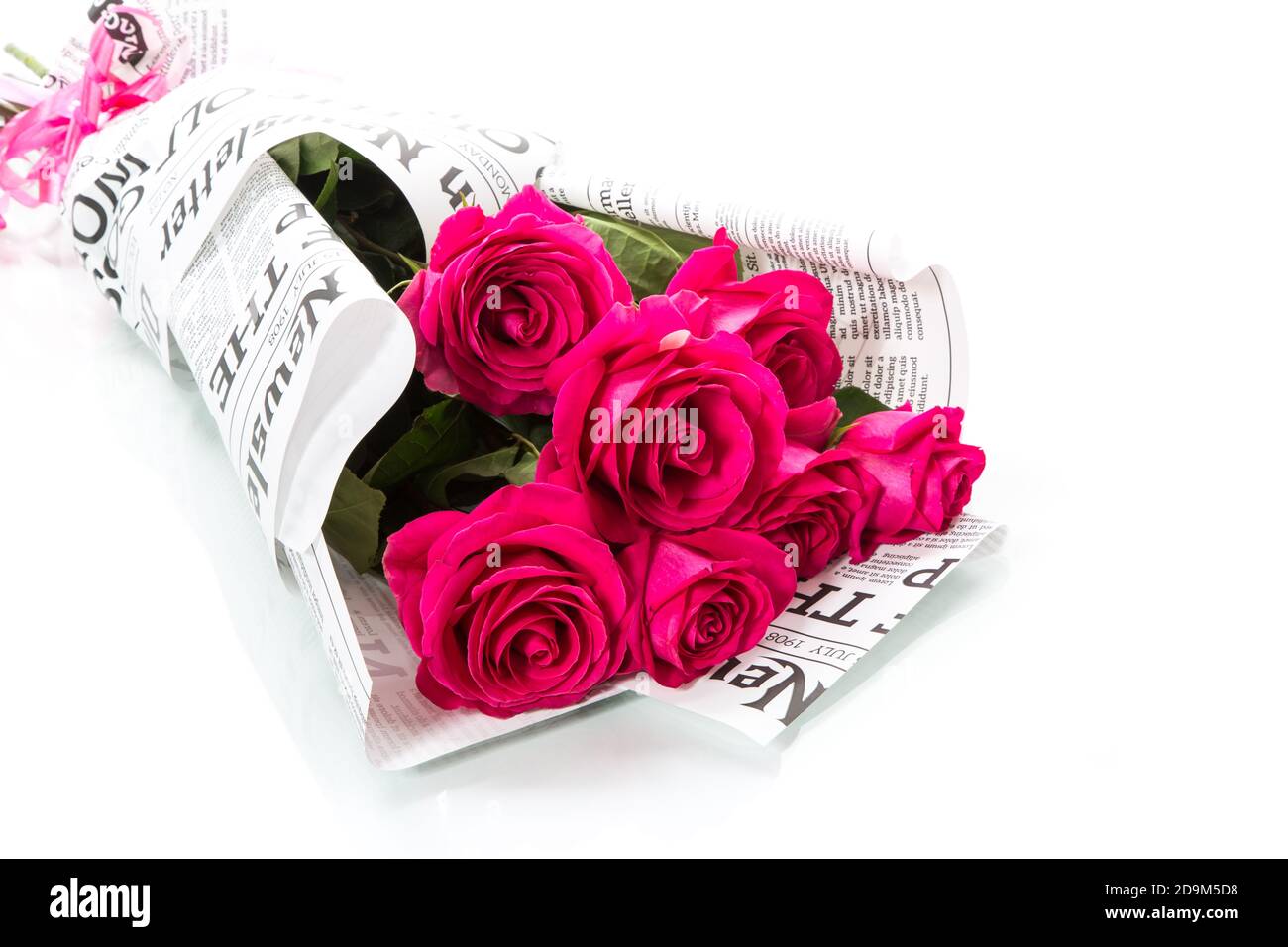 bouquet of beautiful red roses in newspaper wrapper Stock Photo Alamy