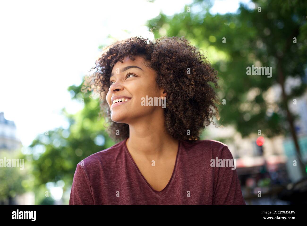 Close up portrait smiling young african american woman with curly hair ...