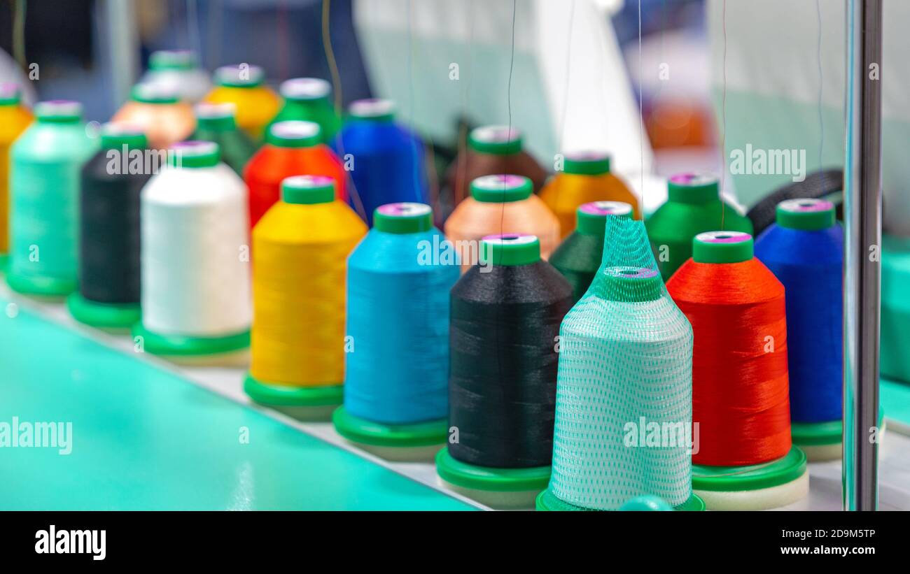 Many Colours Yarns Spools Bobbins at Sewing Machine Stock Photo