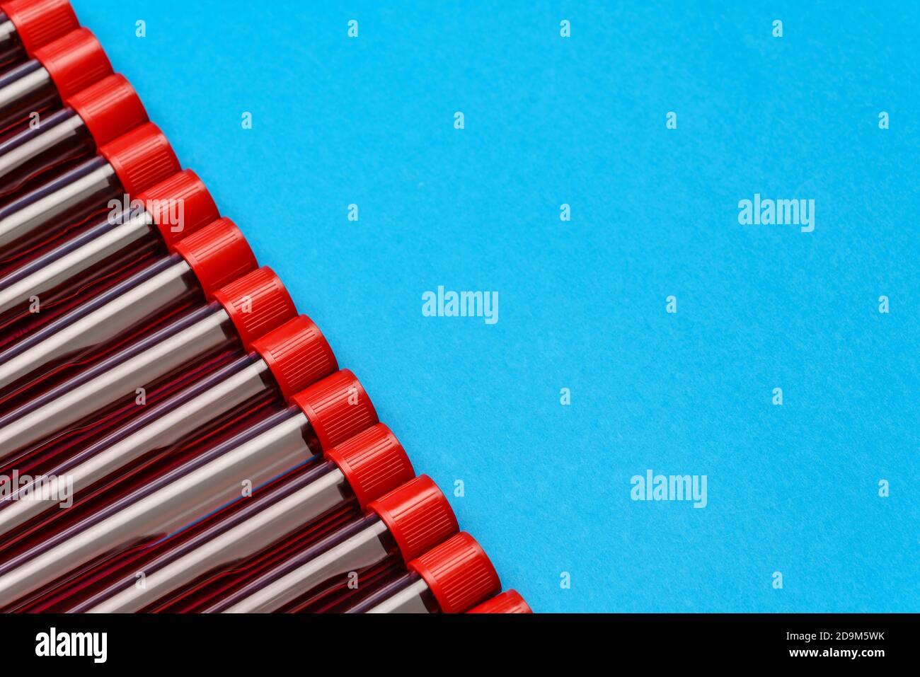 frame made of medicine test tubes with blood samples over blue ...