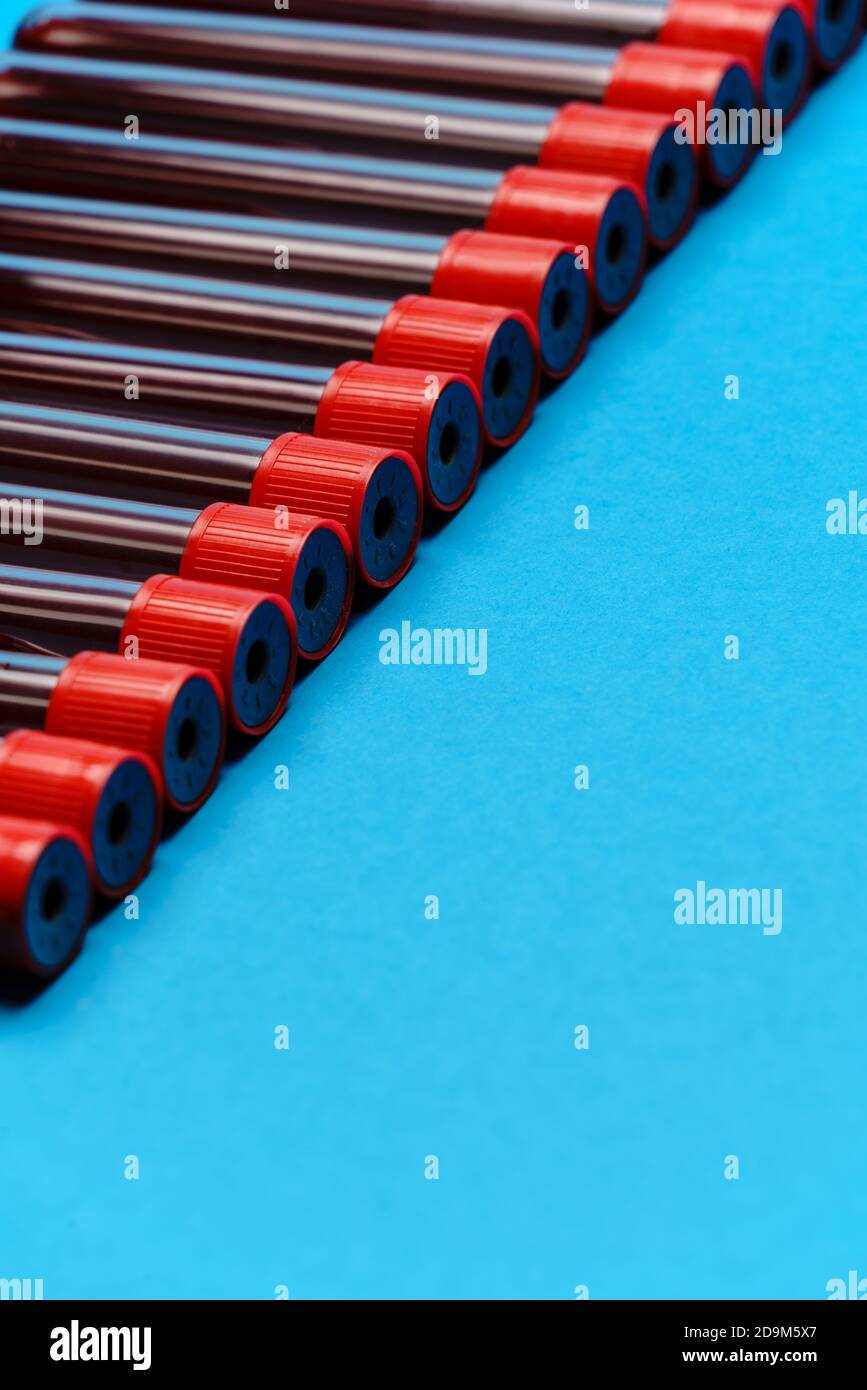 frame made of medicine test tubes with blood samples over blue ...
