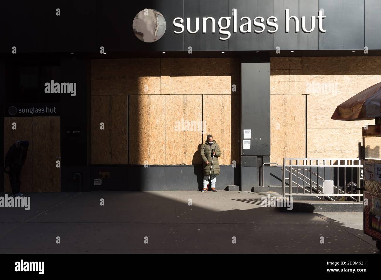 A blind man begs for money outside a subway entrance. Stock Photo