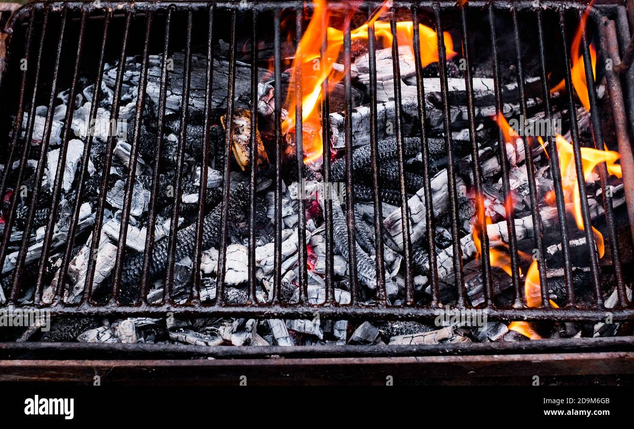 Empty flaming charcoal grill with open fire Stock Photo - Alamy