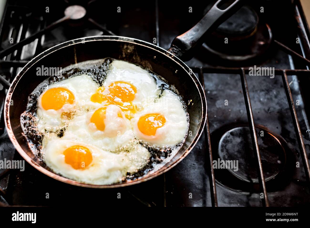 Fried eggs in the pan on the gas stove Stock Photo Alamy