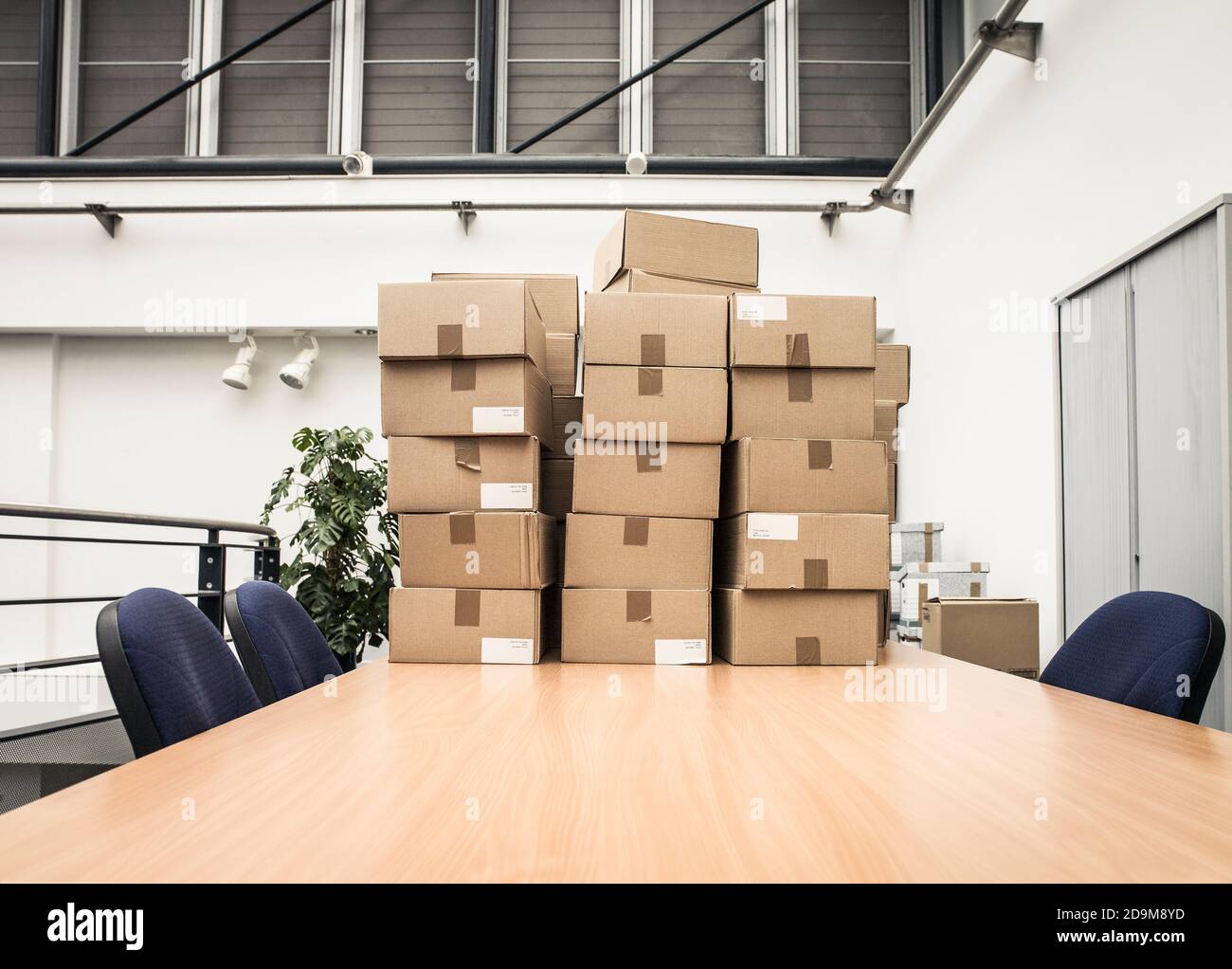 Boxes stacked on office table Stock Photo