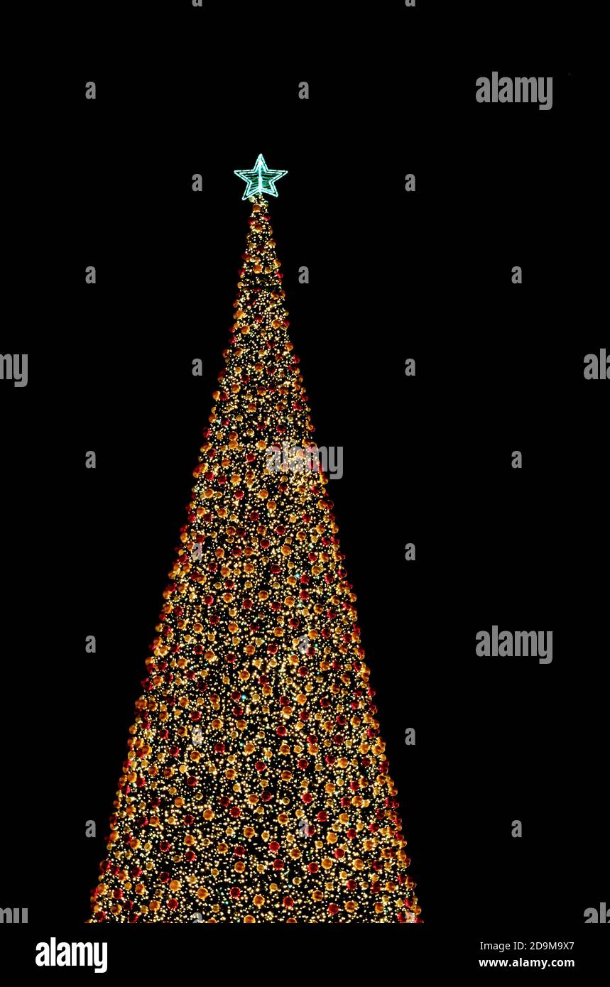 christmas tree with decorates balls and large beautiful star at the top ...