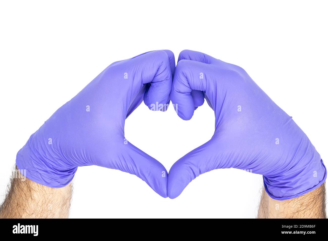 Hands of a doctor or nurse with medical gloves depict a heart isolated on a white background, medicine concept Stock Photo