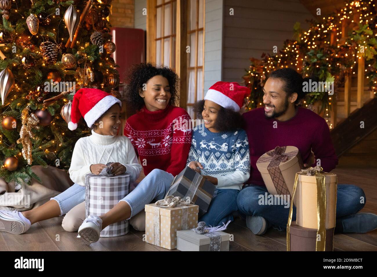 Overjoyed African American family with kids unpacking Christmas gifts Stock  Photo - Alamy