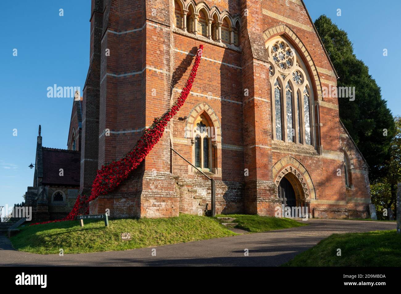 Lyndhurst, Hampshire, UK. 6th November, 2020. The Poppy Appeal has had to adapt this year because of the second lockdown in England due to the coronavirus covid-19 pandemic, and people have been finding different ways to commemorate Remembrance Day. The Church of St Michael's and All Angels in Lyndhurst has been decorated with knitted and crocheted red poppies made by the local community to create a 'fall of poppies for our fallen'. Stock Photo