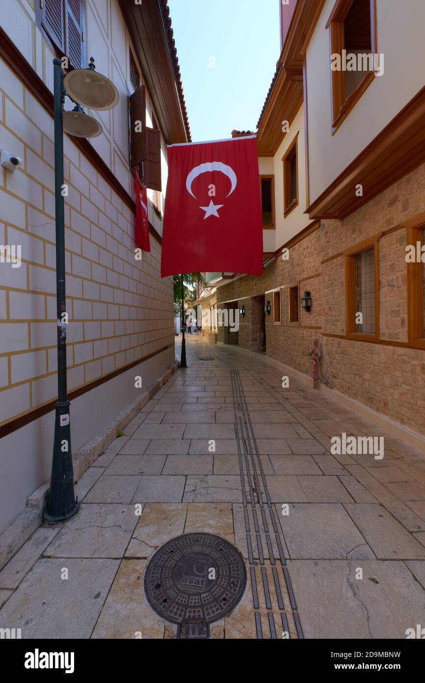 Big Turkey flag in Kaleici district narrow street in Antalya old town Stock Photo