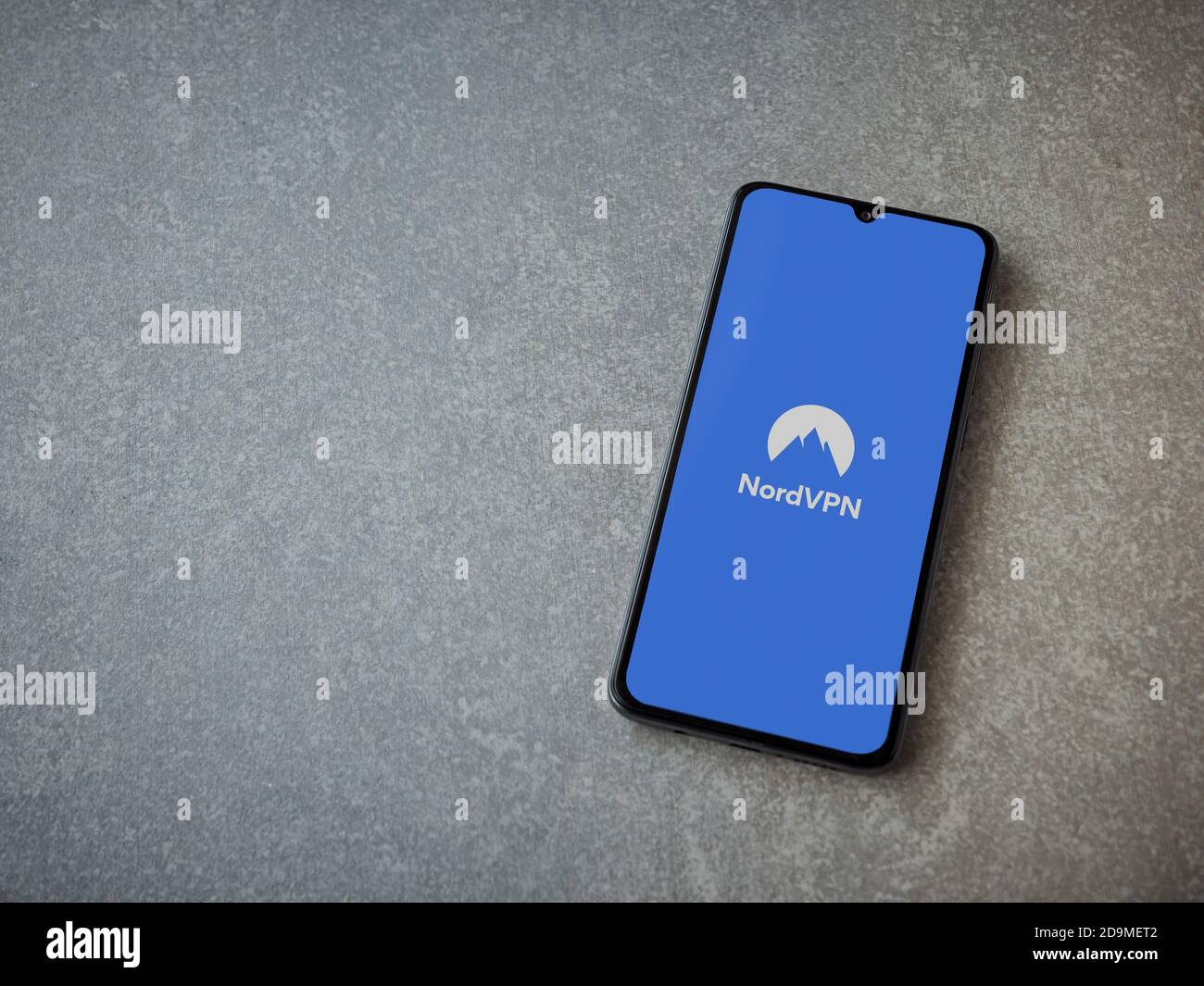 Lod, Israel - July 8, 2020: NordVPN app launch screen with logo on the display of a black mobile smartphone on ceramic stone background. Top view flat Stock Photo