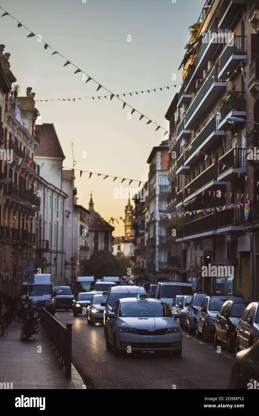 road full of cars on a street in madrid at sunset Stock Photo