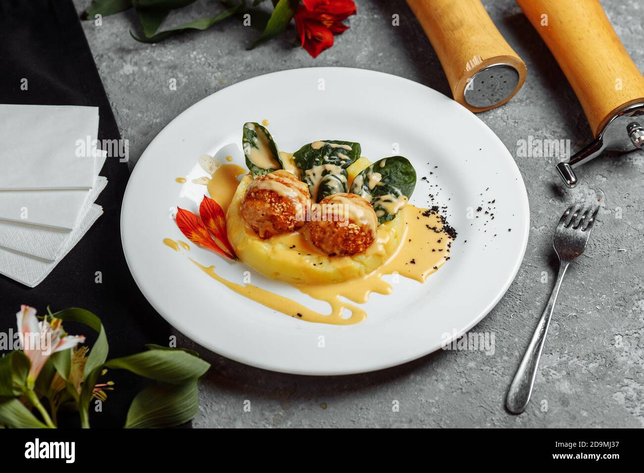 Mashed potatoes with cheese balls in sauce. cheese balls breaded and