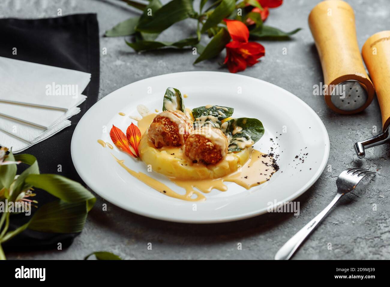 Mashed potatoes with cheese balls in sauce. cheese balls breaded and