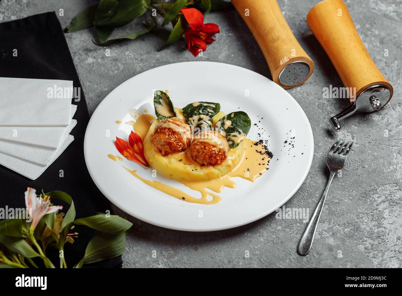 Mashed potatoes with cheese balls in sauce. cheese balls breaded and