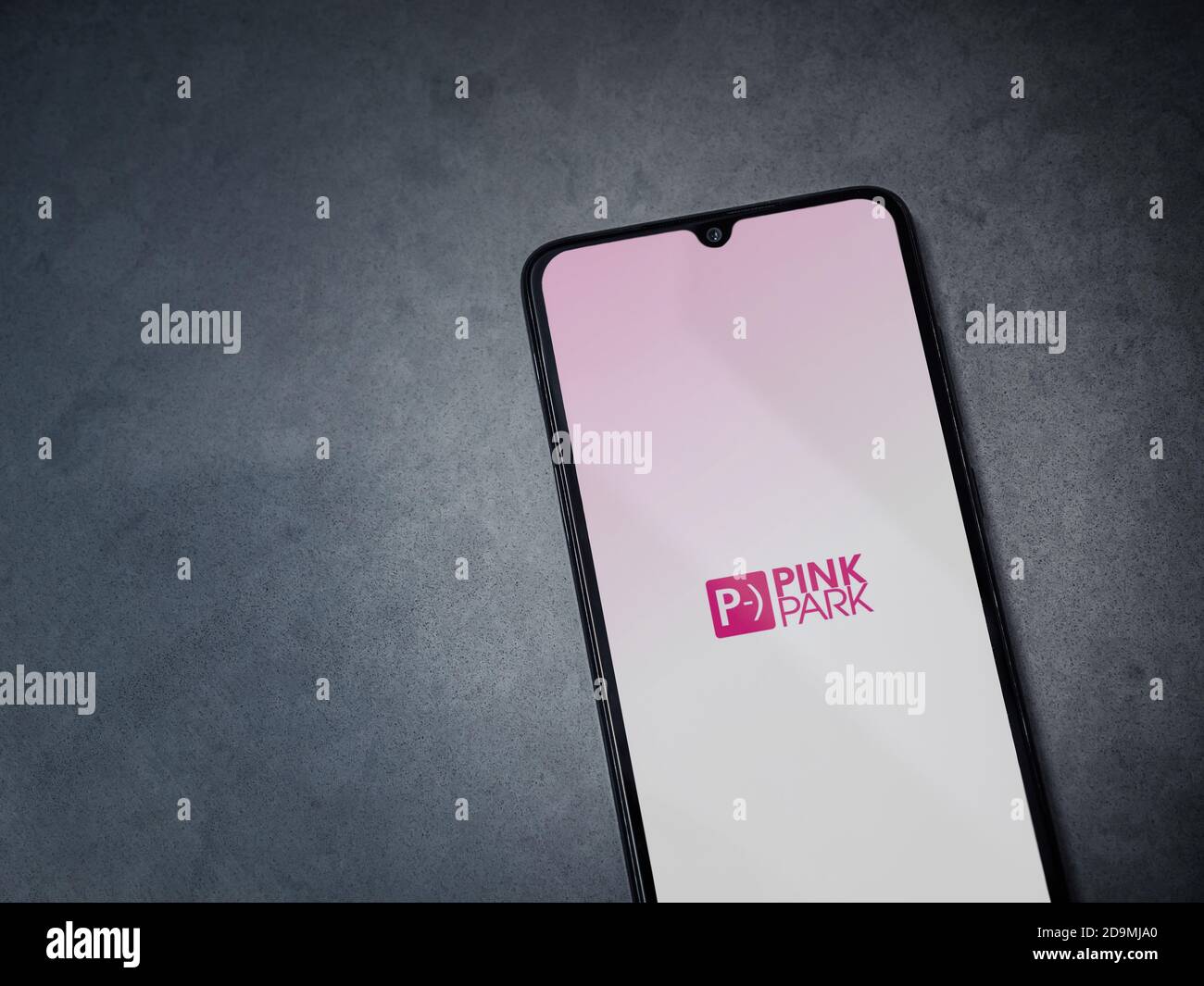 Lod, Israel - July 8, 2020: Pink Park app launch screen with logo on the display of a black mobile smartphone on dark marble stone background. Top vie Stock Photo