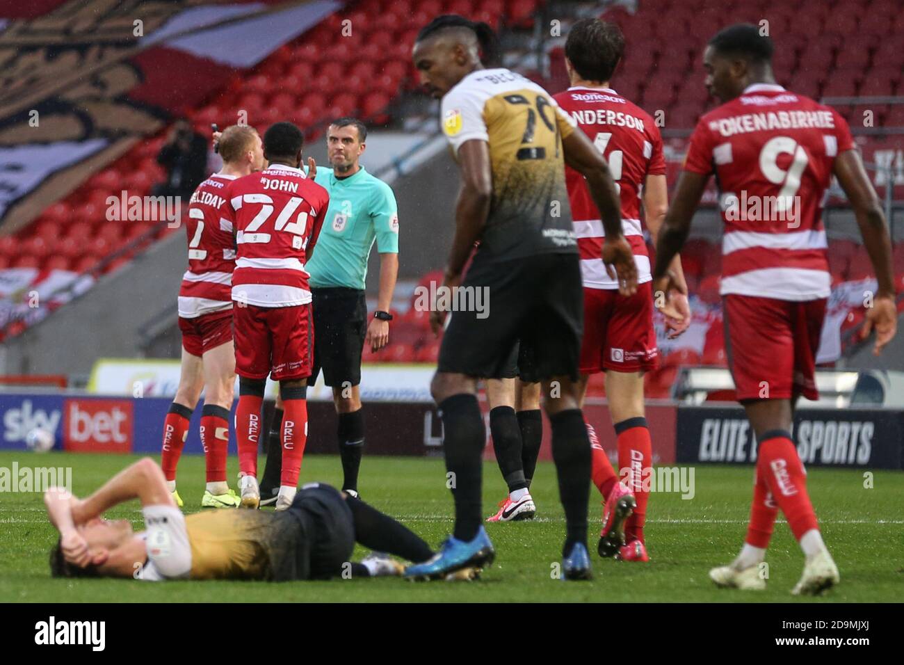 Cameron John (24) of Doncaster Rovers and Brad Halliday (2) of Doncaster Rovers are seen unhappy with the referees decision Stock Photo
