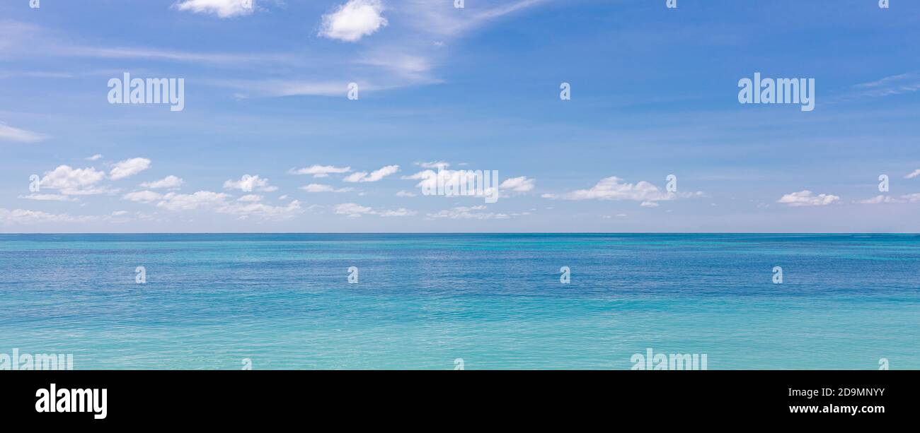 Relaxing tropical seascape with wide horizon of the sky and the sea. Peaceful ocean water, surf, waves, calmness concept. Endless sea horizon Stock Photo