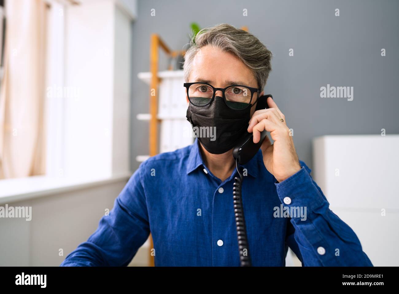 Business Man Talking On Phone Or Telephone In Mask Stock Photo