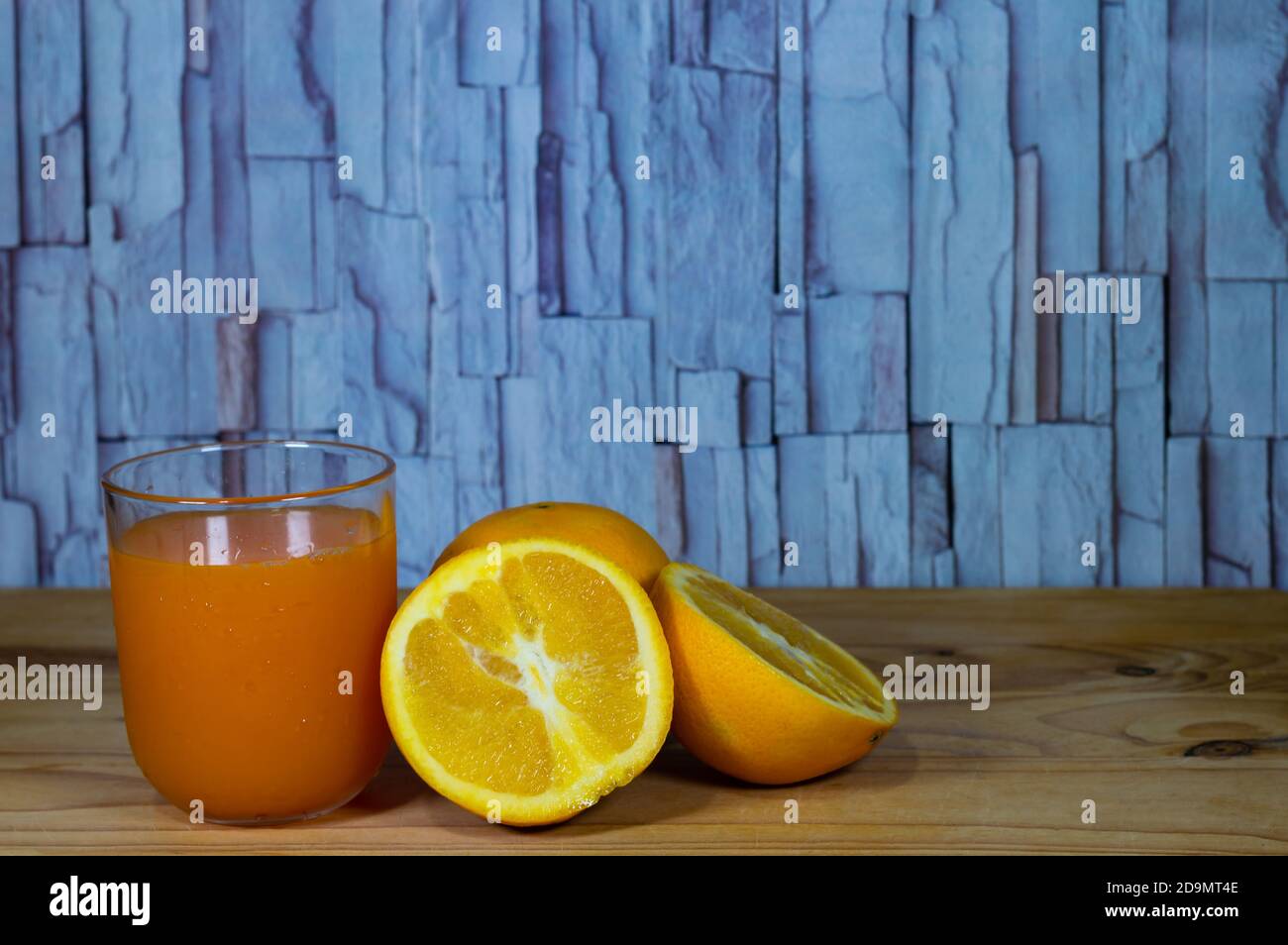 Orange juice glass on wooden table Stock Photo
