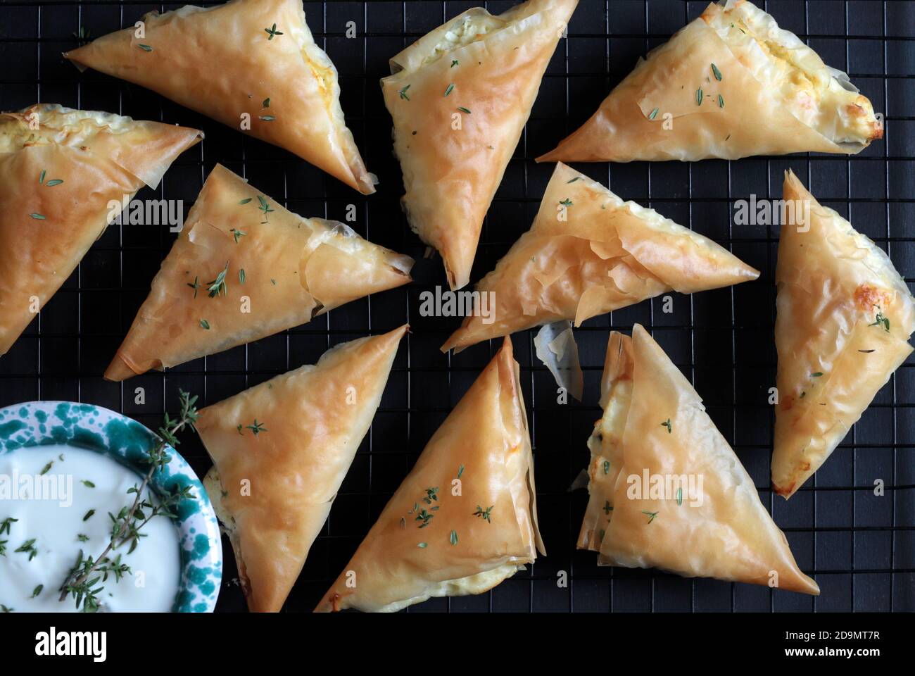 Greek cuisine. Tiropita with feta cheese and phyllo pastry on dark