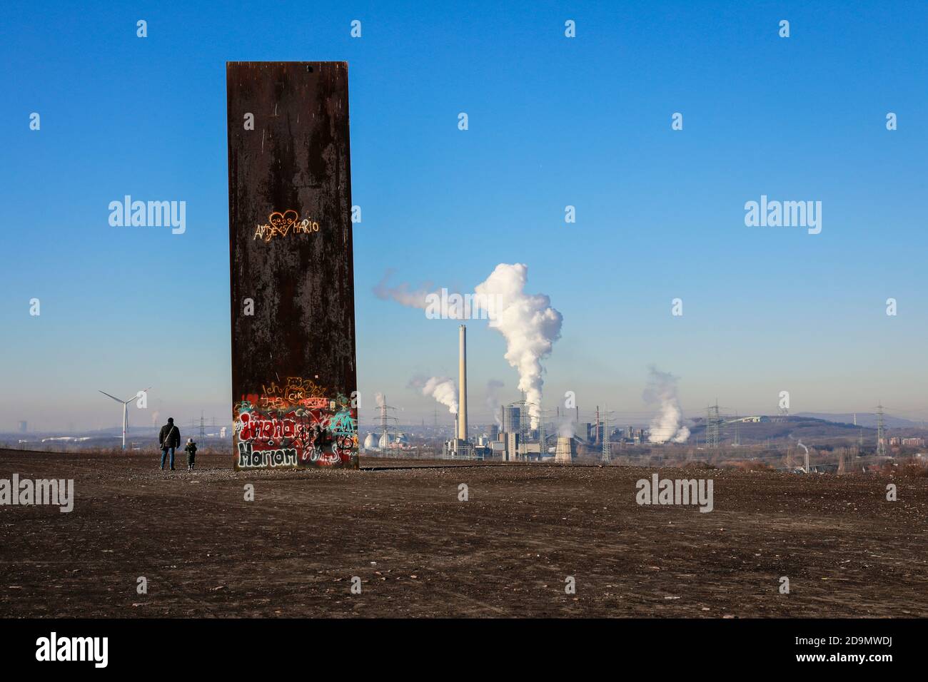 Essen, Ruhr area, North Rhine-Westphalia, Germany, the Schurenbach dump with the sculpture slab for the Ruhr area by Richard Serra, behind the RWE Carnap waste-to-energy plant and the Prosper coking plant in Bottrop. Stock Photo