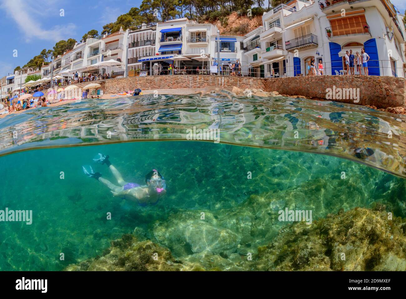 Split level shot of a snorkeler on the house reef in Tamariu, Costa Brava, Spain, Mediterranean Stock Photo