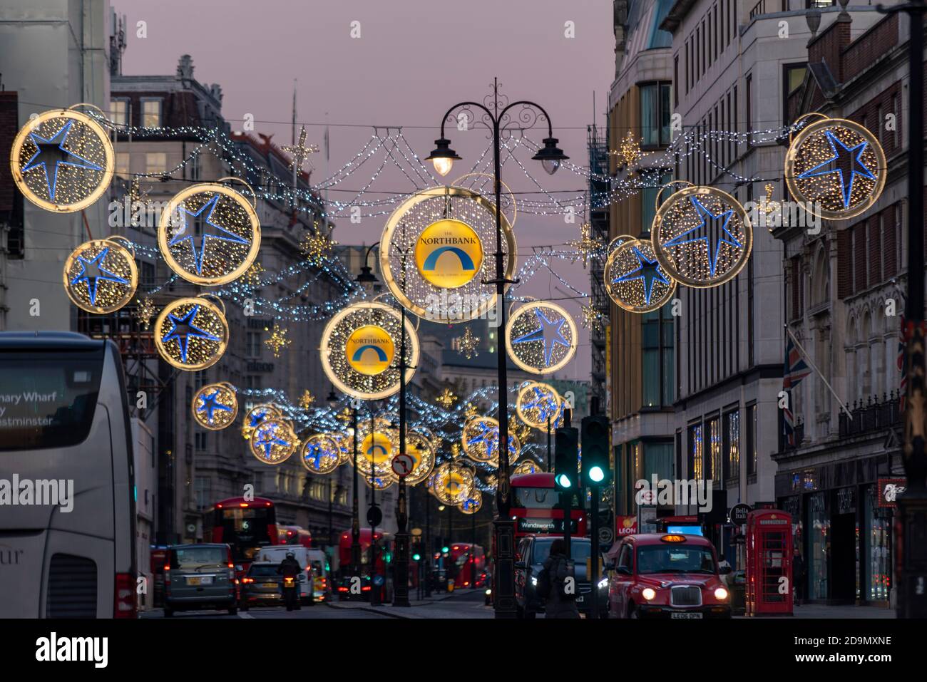 Christmas lights in the Strand, London, UK, at dusk. Main retail road and busy through route. The Northbank Stock Photo
