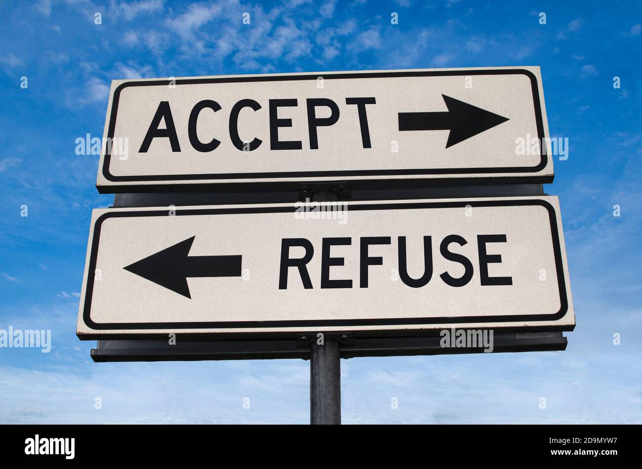 Accept vs refuse. White two street signs with arrow on metal pole with word. Directional road. Crossroads Road Sign, Two Arrow. Blue sky background. T Stock Photo