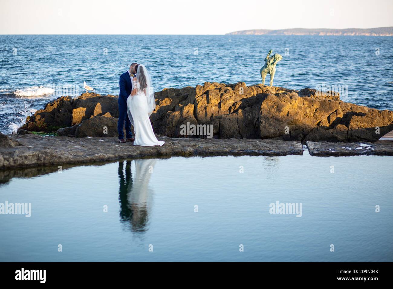 Loving newlyweds kissing on the ocean shore Stock Photo - Alamy