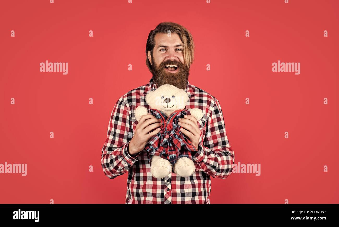 Romantic greeting. Man with beard hold cute toy bear. Man holds teddy bear. Gifts and holidays concept. This is for you. hipster like animal toy. Birthday holiday party celebration. feel happiness. Stock Photo