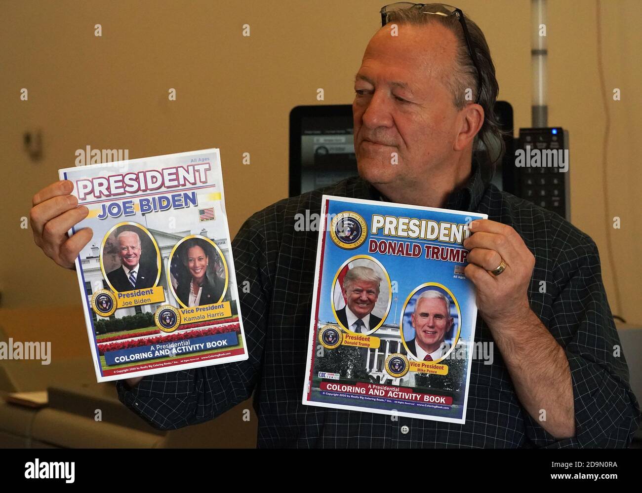 Olivette, Missouri, USA. 06th Nov, 2020. Wayne Bell, Founder and CEO of Really Big Coloring Books, Inc. displays the new coloring books showing the Joe Biden and Donald Trump campaigns as the newly elected President of the United States, at their Olivette, Missouri office on Friday, November 6, 2020. One version will be printed as soon as election results are official. This coloring book is designed for children and parents alike that contains patriotic songs, historical locations and pages describing how children may be involved in their local community, along with games, mazes and puzzles. P Stock Photo