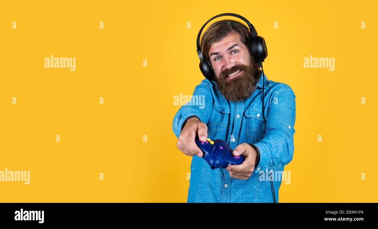 Play hard. hobby. just have fun. new technology in modern life. happy gamer  play computer games. man playing video games. online game. concept of tv  gaming. man in headphones with console. copy