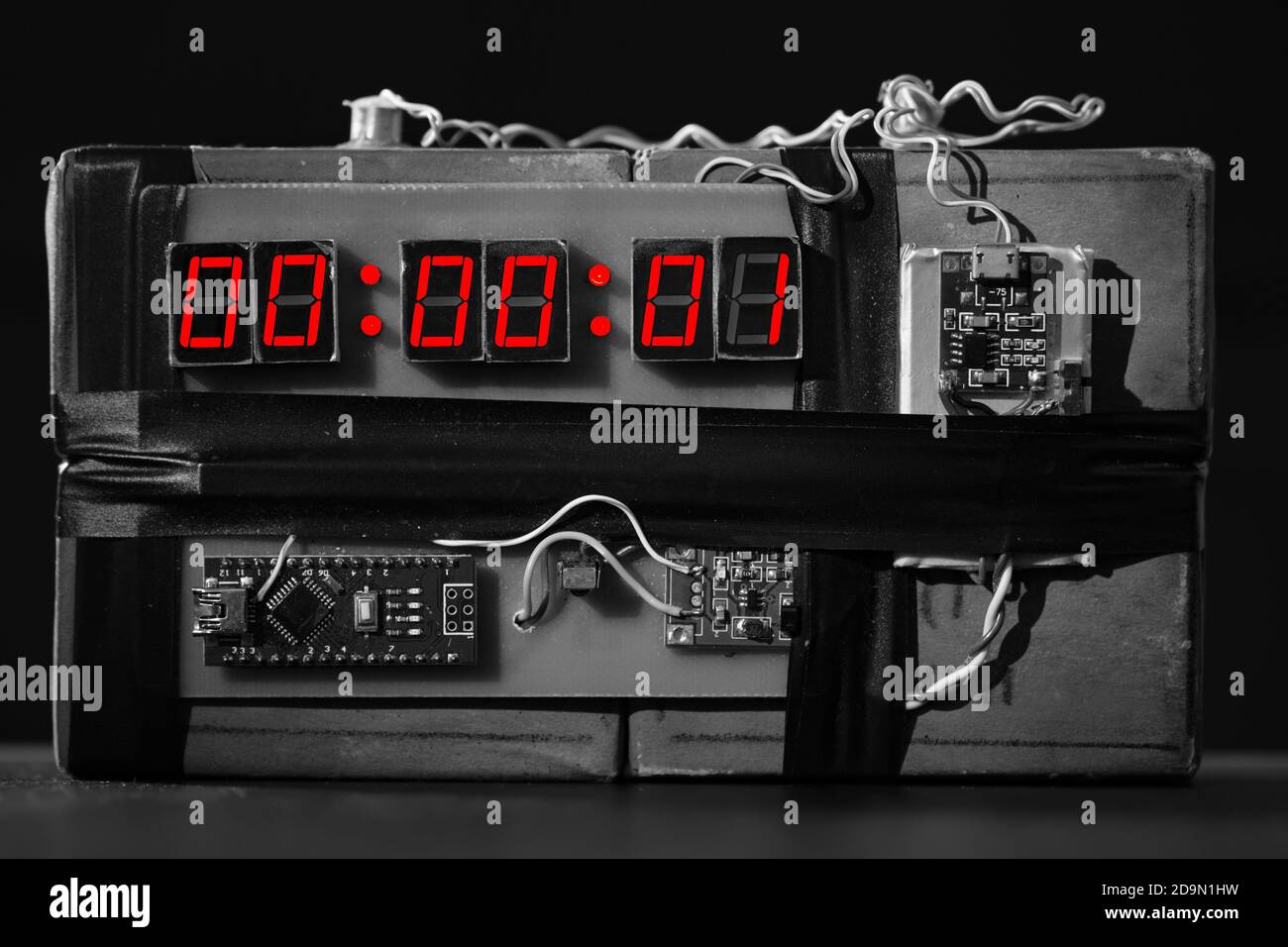 bw. Bomb with a Red Timer on Black Background. Dynamite is Going to Explode or Detonate per 1 Second. Time Bomb with Clockwork. Terrorist Threat. Expl Stock Photo