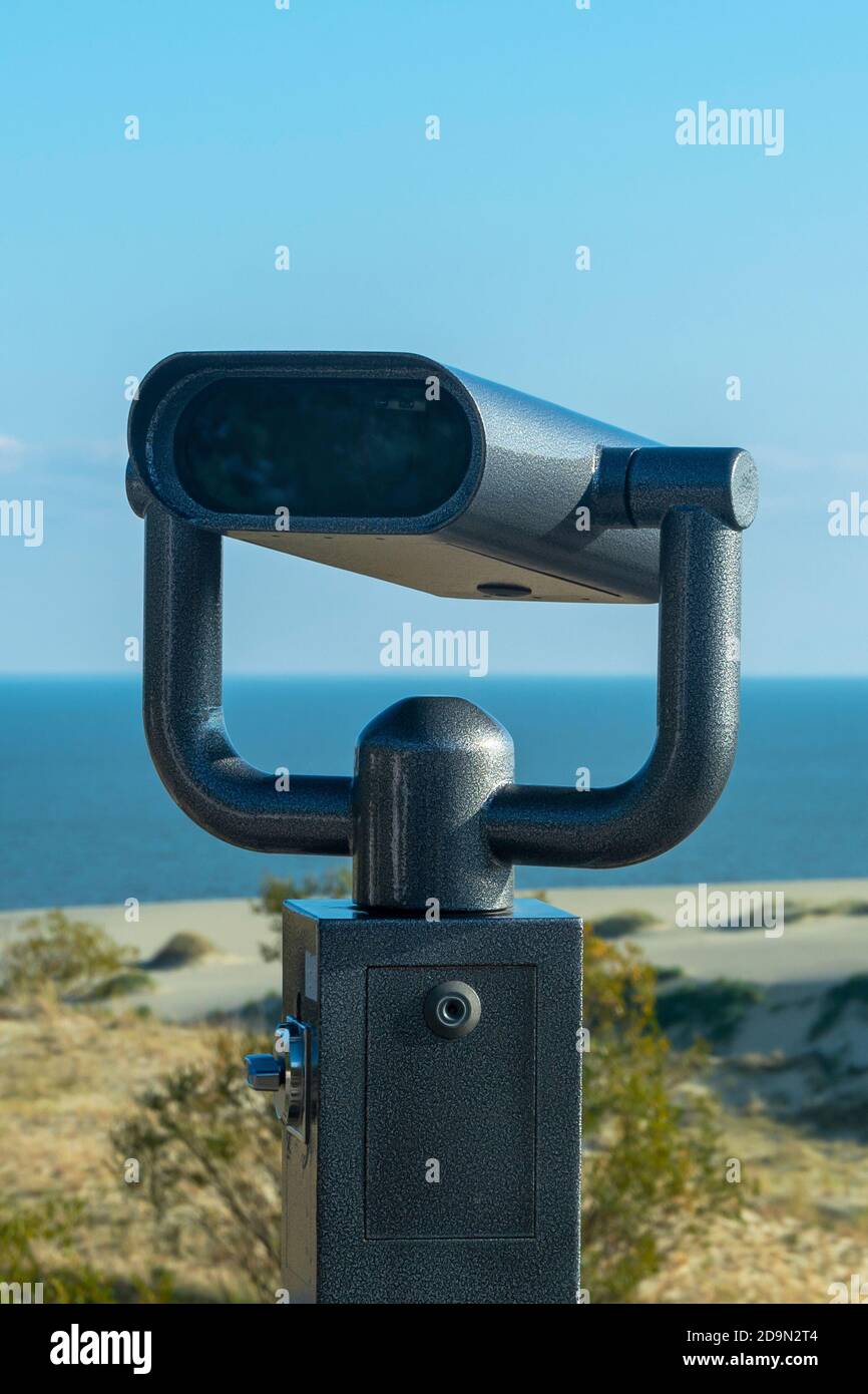 Binoculars in an anti-vandal iron case for a view of sea. Public binocular spectator on the shore. Stock Photo