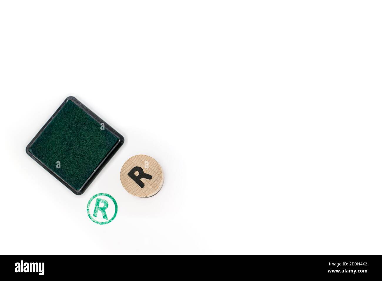 round wooden stamp letter R stamped and pad with green ink Stock Photo ...