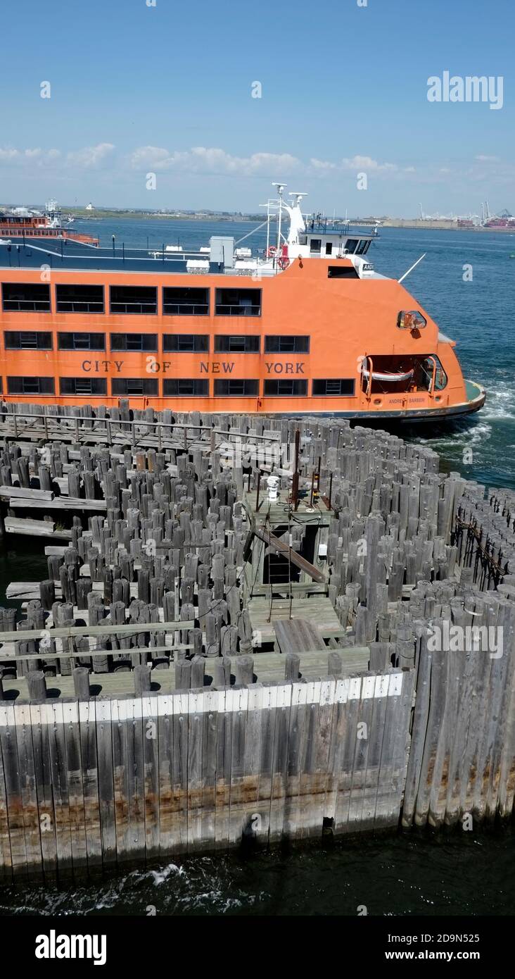 USA, New York, Staten Island Ferry vessel docked at Saint George Terminal in Staten Island amid walls of pressure treated pillars to protect it from high seas Stock Photo