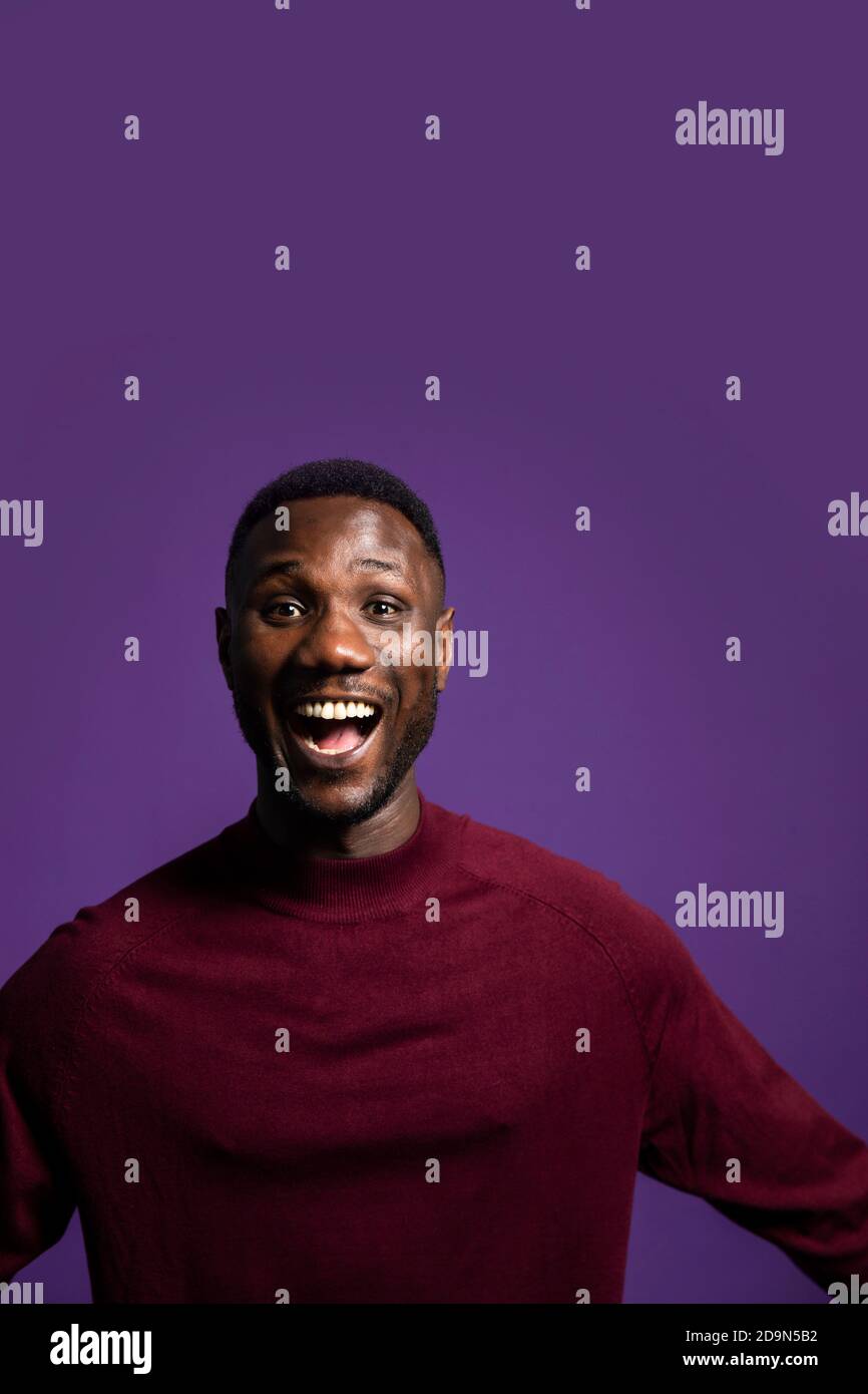 Man with excited open mouth facial expression. Looking at camera. Medium shot. Isolated