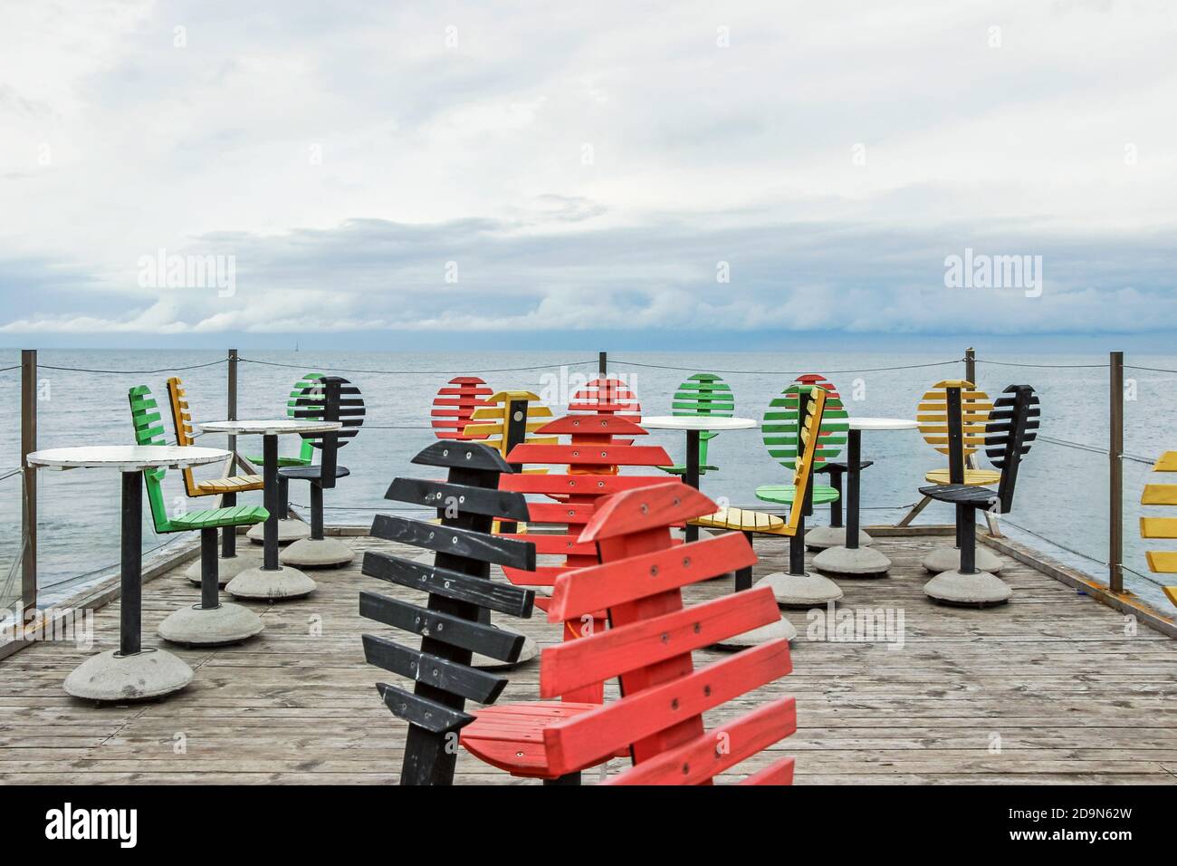 colorful wooden chairs at coastline in Visby Sweden Stock Photo